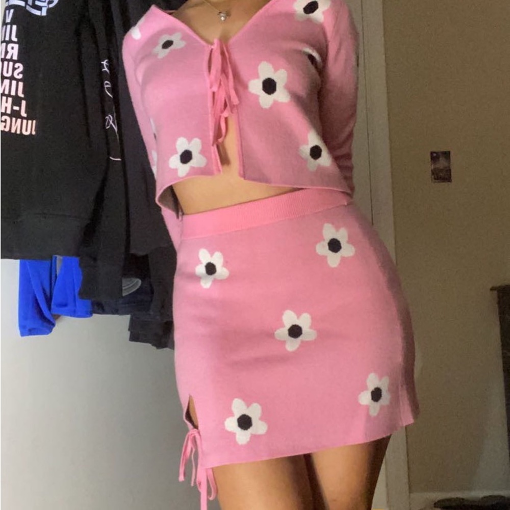 Pink with white flowers,brand Is Lottie moss, it’s a size small.